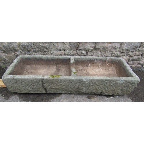 1103 - A weathered carved natural stone planter of two divisional rectangular form, 19cm high, 108 x 39cm. ... 