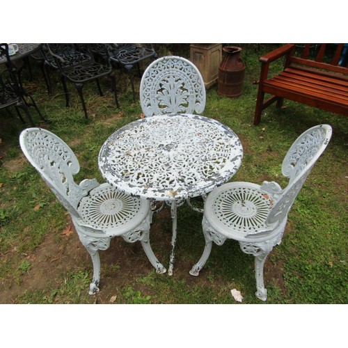 1058 - A painted and weathered cast aluminium garden terrace table of circular form with decorative pierced... 