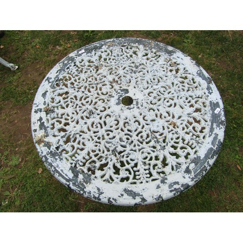 1058 - A painted and weathered cast aluminium garden terrace table of circular form with decorative pierced... 