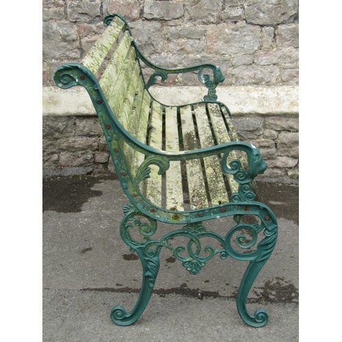 1078 - A two seat garden bench with weathered wooden slatted seat and combined back raised on decorative pa... 