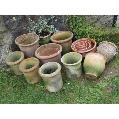 1080 - A collection of weathered terracotta planters of varying size and design including a few examples wi... 