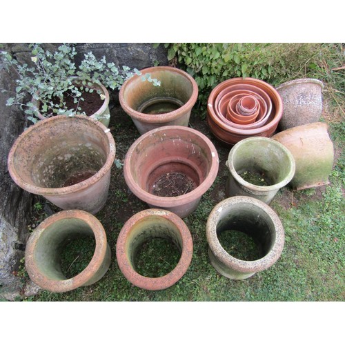 1080 - A collection of weathered terracotta planters of varying size and design including a few examples wi... 