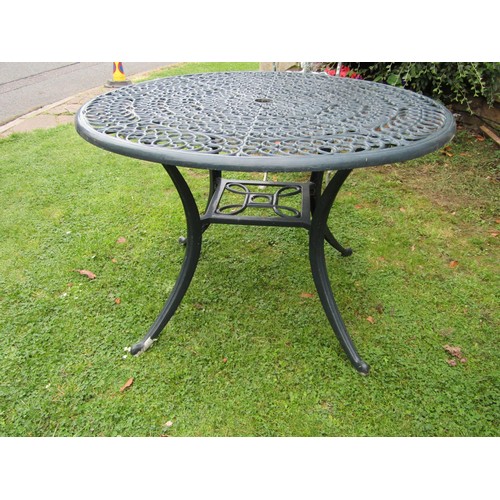 1085 - Green painted cast alloy garden terrace table of circular form with decorative pierced top 108 cm di... 