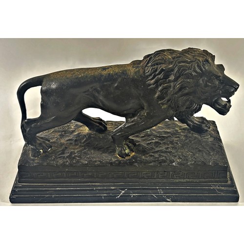 509 - A bronzed study of a male lion after Barye raised on a stepped marble plinth, 37cm wide x 26cm high.