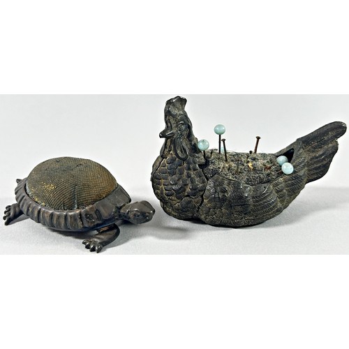 383 - A silver tortoise pin cushion together with a pewter chicken pin cushion