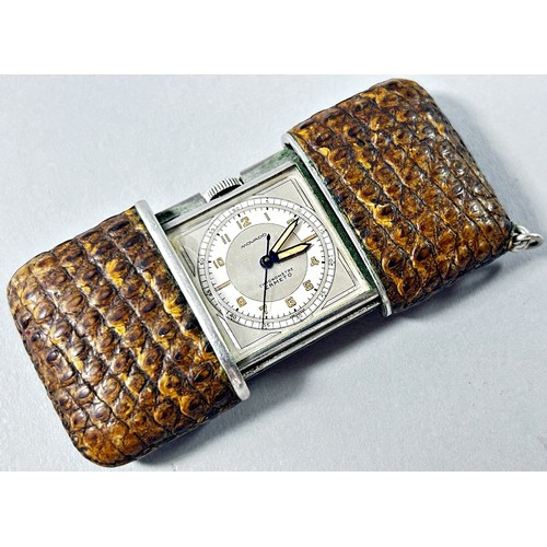 376 - A Movado travelling chronometer, snake skin cover