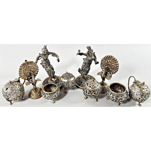 272 - A pair of Indian silver metal peacock menu holders, a pair of Thai silver metal dancers and six Indi... 