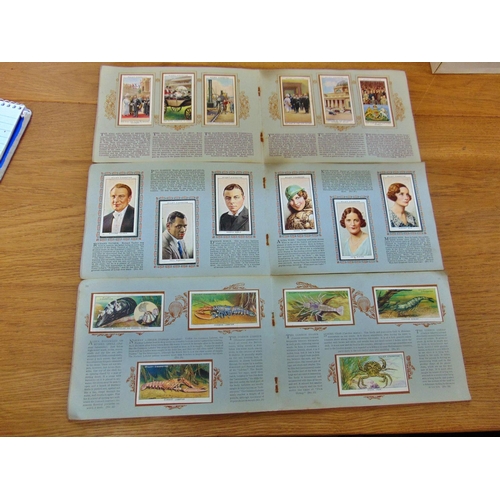 691 - A collection of nineteen cigarette card albums of various eras (to include The Reign of King George ... 