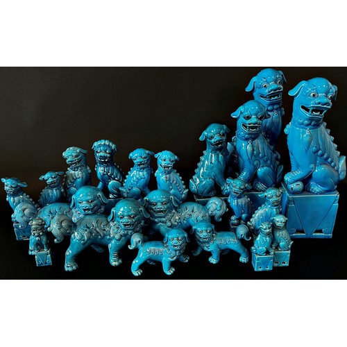 105 - Twenty Chinese ceramic Dogs of Fo, various sizes and designs, all in a blue colourway, 36cm high and... 