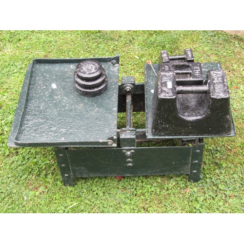 1117 - A heavy duty set of antique iron agricultural scales, with painted finish and associated weights.