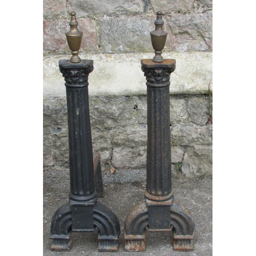 1123 - A pair of antique country house iron fire dogs, in the form of tapering fluted pilasters with brass ... 