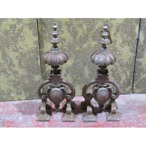 1125 - A large pair of decorative weathered ironwork fire dogs, each 70cm high.