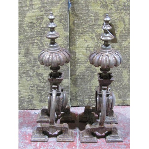 1125 - A large pair of decorative weathered ironwork fire dogs, each 70cm high.