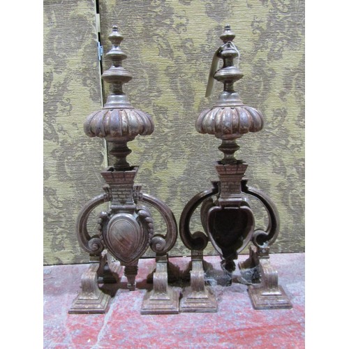 1125 - A large pair of decorative weathered ironwork fire dogs, each 70cm high.