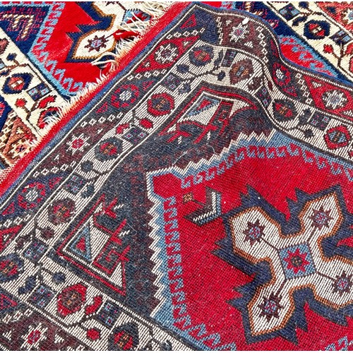 1761 - A Kazak type runner with seven star medallions on a red ground, 300cm x 80 cm