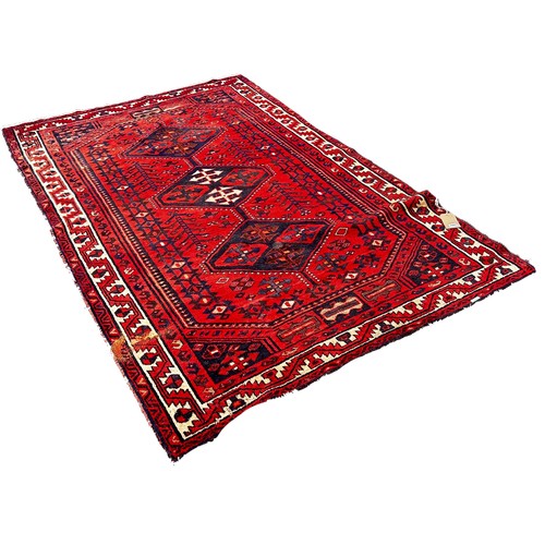 1762 - An old Turkoman carpet with three central medallions on a predominantly red ground, 250cm x 160cm ap... 