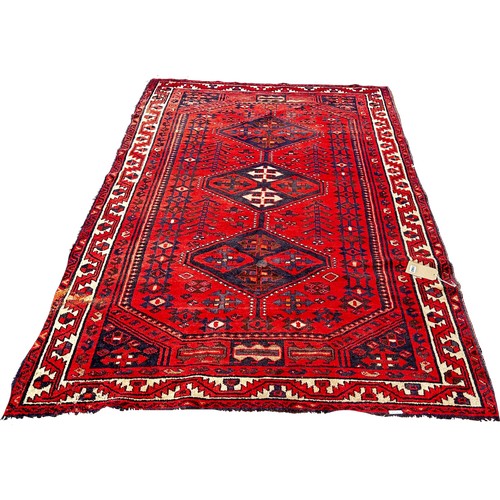 1762 - An old Turkoman carpet with three central medallions on a predominantly red ground, 250cm x 160cm ap... 