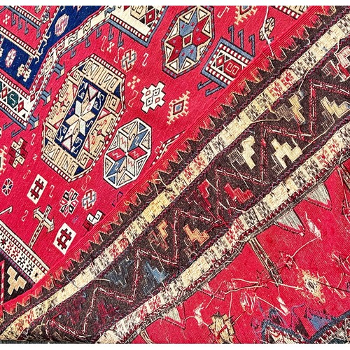 1766 - A Middle Eastern flat weave carpet with two lozenge shaped medallions on a pink ground, 275cm x 190c... 