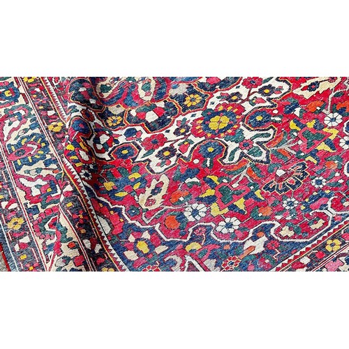 1777 - A Persian Bakthiari carpet with an all over multicoloured floral pattern 295cm x 210cm approximately