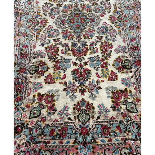 1780 - A Middle Eastern style rug with an all over floral pattern, 220cm x 120cm