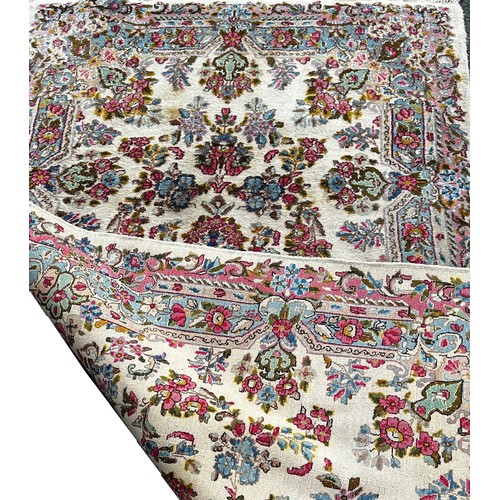 1780 - A Middle Eastern style rug with an all over floral pattern, 220cm x 120cm