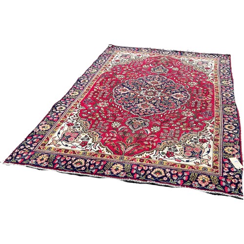 1787 - A Tabriz style carpet with a central floral medallion on a floral red ground, 260cm x 180cm approxim... 