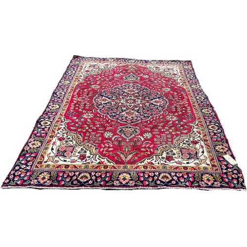 1787 - A Tabriz style carpet with a central floral medallion on a floral red ground, 260cm x 180cm approxim... 