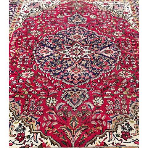 1787 - A Tabriz style carpet with a central floral medallion on a floral red ground, 260cm x 180cm approxim... 