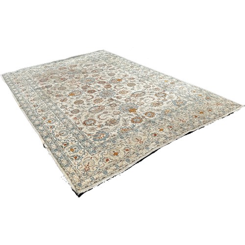 1791 - A Persian hand made carpet circa 1950’s with an all over floral pattern on an ivory ground, 335cm x ... 