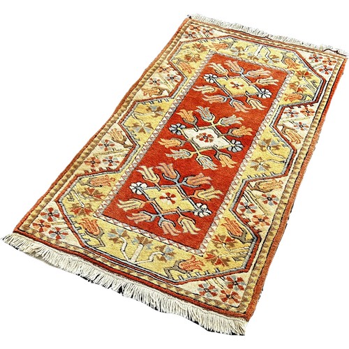 1795 - A small Persian wool rug, geometric design, orange and a cream 135cm x 80cm approximately