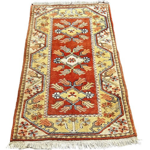 1795 - A small Persian wool rug, geometric design, orange and a cream 135cm x 80cm approximately