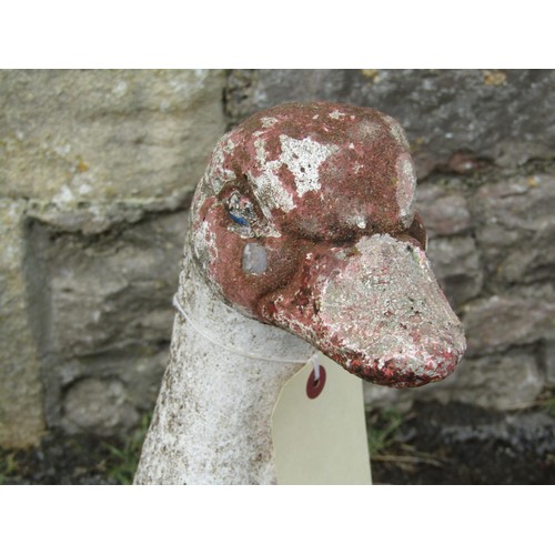 1138 - A pair of weathered painted composition stone geese garden ornaments, each 60cm high.