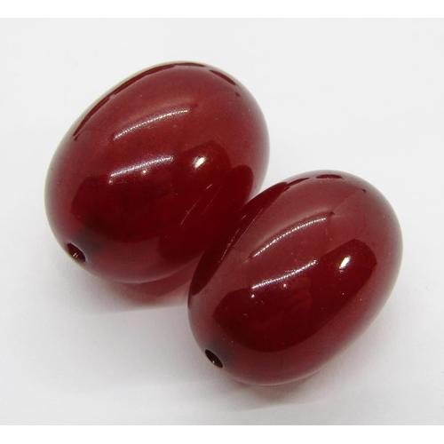 354 - Collection of cherry amber coloured beads, largest 2.9 x 2.1cm approx, 59.2g total