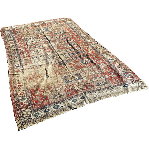 1784 - An old Sumak carpet, very worn and faded, repeating geometric patterns, 300cm x 165cm approximately