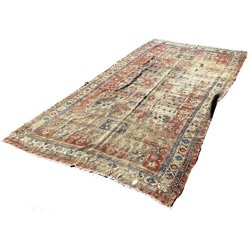 1784 - An old Sumak carpet, very worn and faded, repeating geometric patterns, 300cm x 165cm approximately