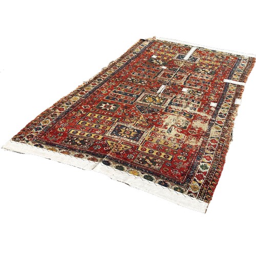 1784 - An old Sumak carpet, very worn and faded, repeating geometric patterns, 300cm x 165cm approximately