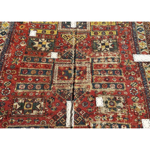 1784 - An old Sumak carpet, very worn and faded, repeating geometric patterns, 300cm x 165cm approximately