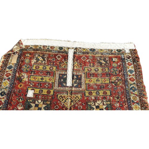 1784 - An old Sumak carpet, very worn and faded, repeating geometric patterns, 300cm x 165cm approximately