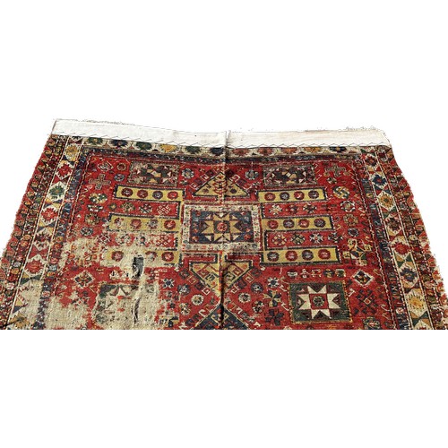 1784 - An old Sumak carpet, very worn and faded, repeating geometric patterns, 300cm x 165cm approximately