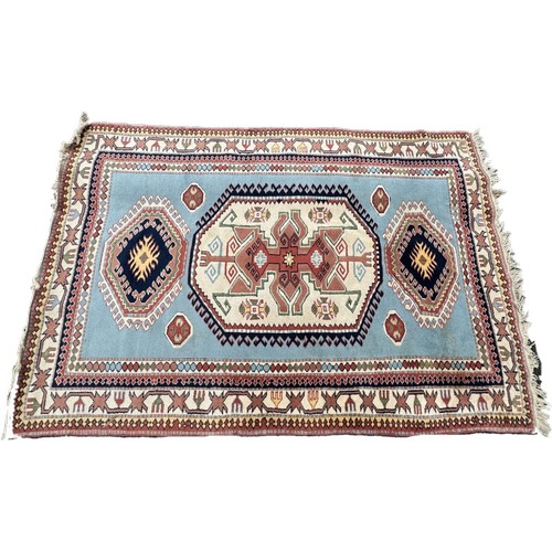 1767 - A Kazak rug in sky blue, indigo, scarlet and natural wool tones, 255 x 180 cm