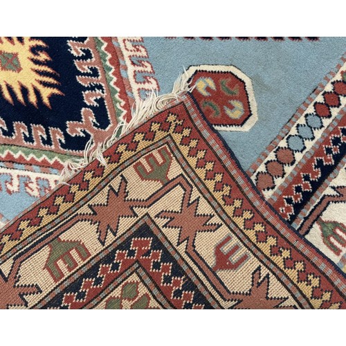 1767 - A Kazak rug in sky blue, indigo, scarlet and natural wool tones, 255 x 180 cm