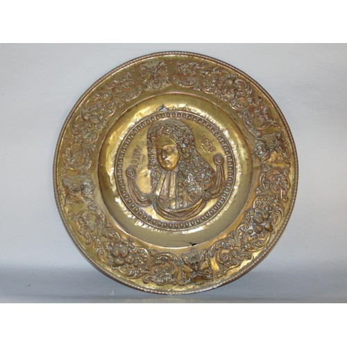 463 - A decorative late 19th century brass charger decorated with a stylised owl before crescent moon and ... 