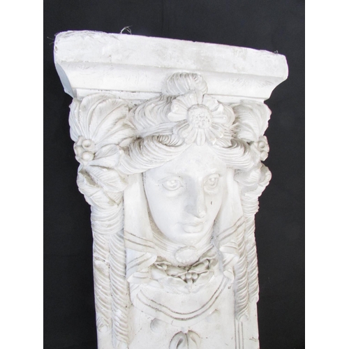 514 - A decorative moulded plaster panel in the form of a maiden with floral adornments and further symmet... 