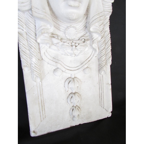 514 - A decorative moulded plaster panel in the form of a maiden with floral adornments and further symmet... 