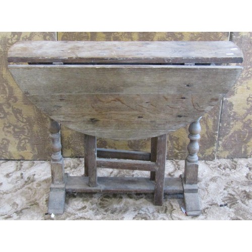 1185 - A primitive antique oak gateleg table of narrow proportions, together with a 19th century pine cover... 