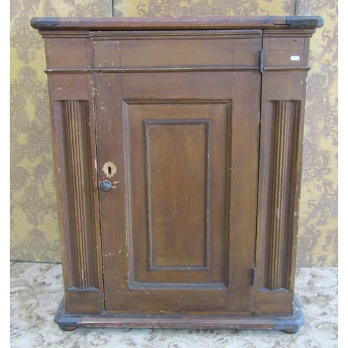 1186 - A 19th century pine hall cupboard with scumbled finish with central hinged panelled door, flanked by... 