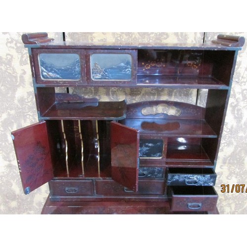 1190 - A 19th century Japanese lacquered writing desk, the raised back enclosing drawers and cupboards, lan... 