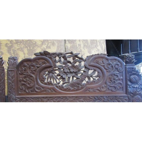 1191 - A late 19th century two panel screen of full height, with carved borders chrysanthemum and other flo... 