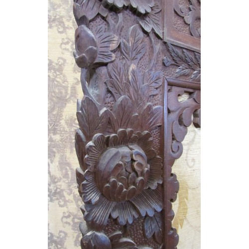 1191 - A late 19th century two panel screen of full height, with carved borders chrysanthemum and other flo... 