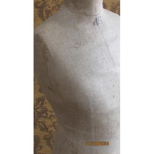 1192 - A late 19th century mannequin of torso form, with linen finish on tripod base